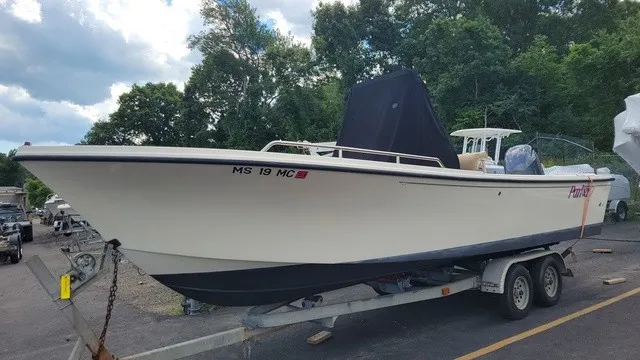 The Image of A 2004 Parker 23 Special Edition boat on a trailer in an outdoor storage area. - 1