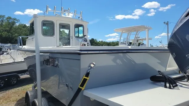 Slide: The Image of A 2020 Parker 2320 SC boat with a cabin and outboard motor, on a trailer. - 4