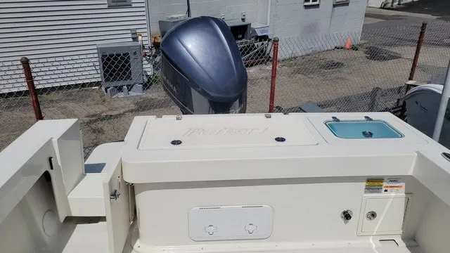 Slide: The Image of The image shows the stern of a 2020 Parker 2320 SC boat with an outboard motor. - 9