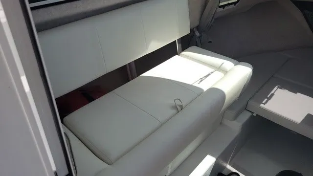 Slide: The Image of Interior of a Parker 2320 SC boat with white upholstery and a table. - 8
