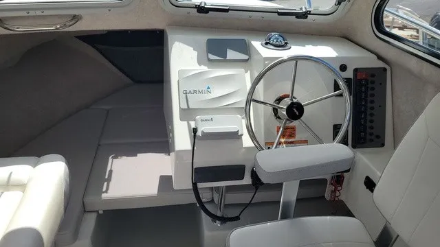 Slide: The Image of Interior of a 2020 Parker 2320 SC boat with helm and Garmin device. - 7