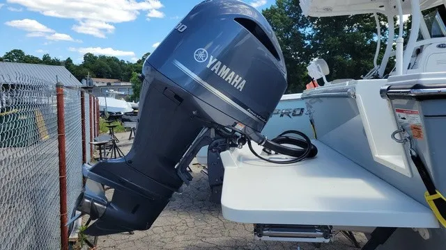 Slide: The Image of A 2020 Parker 2320 SC boat with a Yamaha outboard motor, parked on a concrete lot. - 5