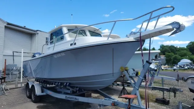 The Image of A 2020 Parker 2320 SC boat is on a trailer in a yard. - 1