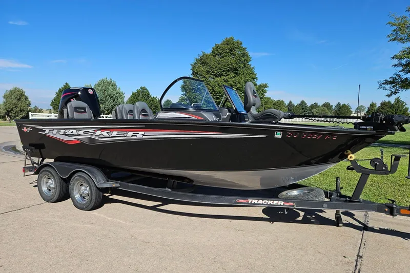 The Image of 2021 Tracker Targa V-19 Combo boat on trailer, parked outdoors on a sunny day. - 0