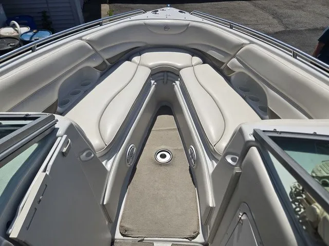 Slide: The Image of The image shows the bow area of a 2003 Crownline 230 BR boat with beige upholstery. - 14