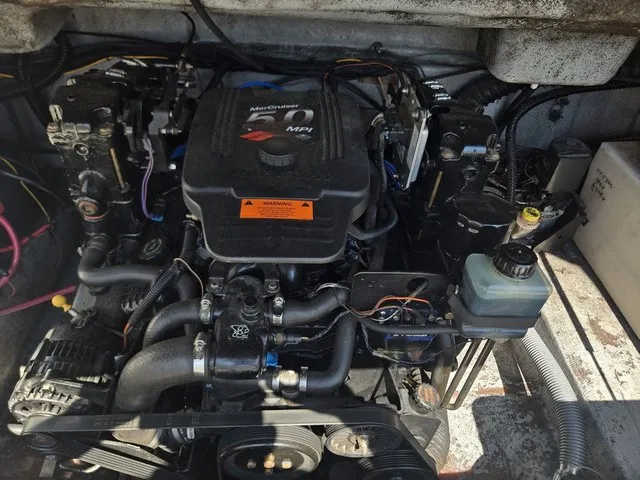 Slide: The Image of An engine compartment with a MerCruiser engine in a 2003 Crownline 230 BR boat. - 19