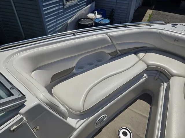 Slide: The Image of The image shows the bow area of a 2003 Crownline 230 BR boat with white cushioned seating. - 15