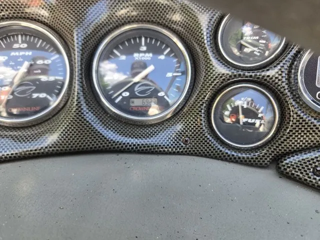 Slide: The Image of Close-up of a 2003 Crownline 230 BR boat dashboard with various gauges. - 18