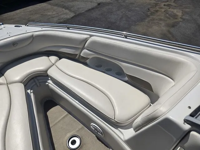 Slide: The Image of The image shows the cream-colored seating in the bow area of a 2003 Crownline 230 BR boat. - 16