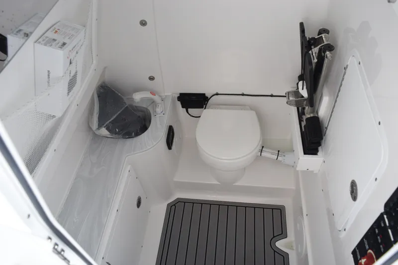 Slide: The Image of Interior of 2027 Sea Hunt Gamefish 30FS boat featuring a compact marine toilet. - 15