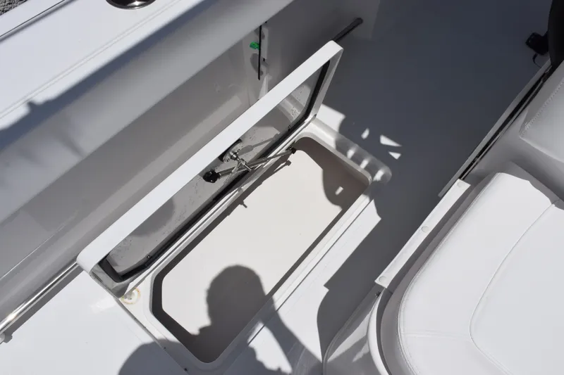 Slide: The Image of 2027 Sea Hunt Gamefish 30FS boat storage compartment with open lid, showcasing interior space. - 19