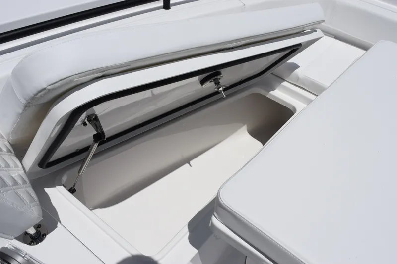 Slide: The Image of 2027 Sea Hunt Gamefish 30FS boat storage compartment with open hatch and cushioned seating. - 18