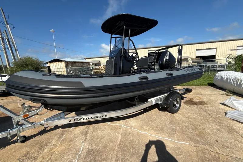 The Image of 2026 Highfield Patrol 540 boat on trailer, parked outdoors under clear sky. - 0