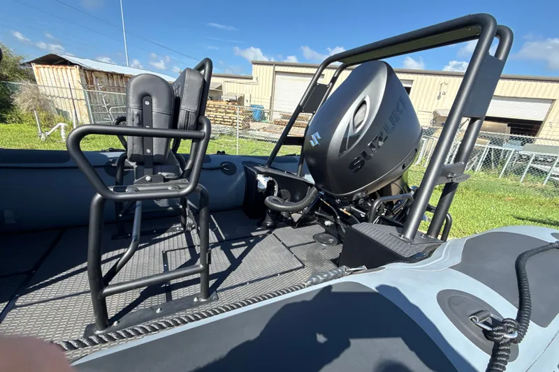 Slide: The Image of Highfield Patrol 540 boat, 2026 model, featuring Suzuki outboard motor and seating, in a sunny outdoor setting. - 2