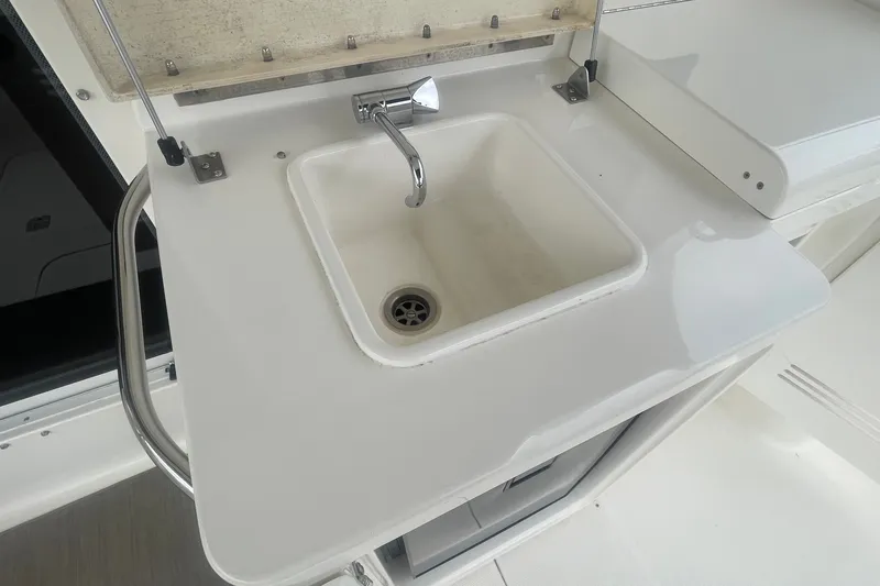 Slide: The Image of White sink on 2006 Silverton 34 Convertible yacht, featuring a sleek chrome faucet. - 23