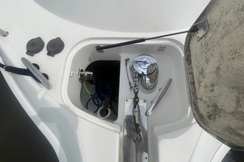 Slide: The Image of Anchor compartment of a 2006 Silverton 34 Convertible boat, featuring a winch and chain. - 19