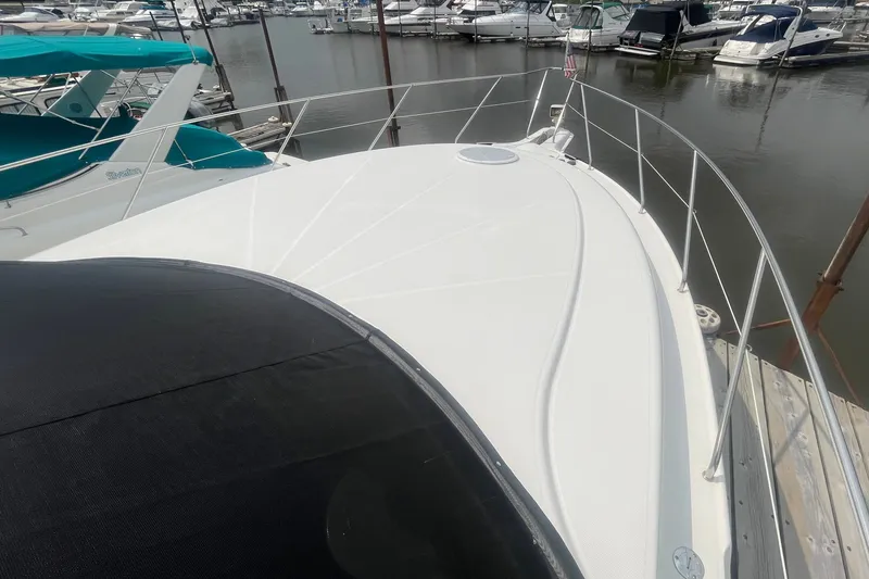 Slide: The Image of 2006 Silverton 34 Convertible yacht docked at marina, showcasing sleek deck design. - 18