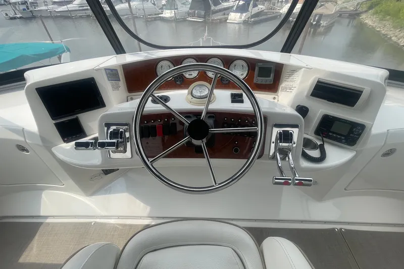 Slide: The Image of Helm of 2006 Silverton 34 Convertible yacht with steering wheel and control panel. - 35