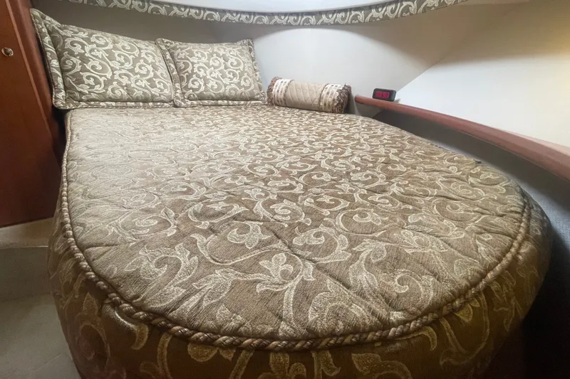 Slide: The Image of Luxurious cabin interior of 2006 Silverton 34 Convertible yacht with patterned bedding. - 60