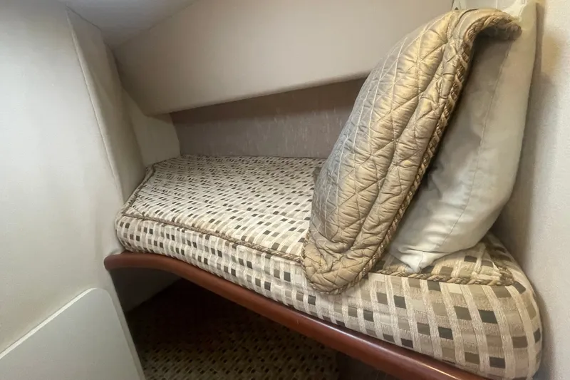 Slide: The Image of Interior cabin of 2006 Silverton 34 Convertible with patterned bedding and pillows. - 56