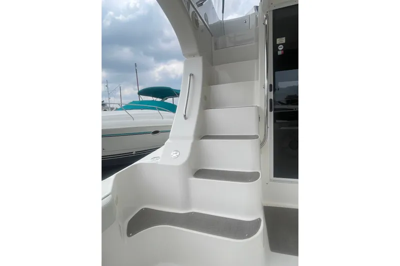 Slide: The Image of Staircase on 2006 Silverton 34 Convertible yacht, leading to upper deck under cloudy sky. - 25