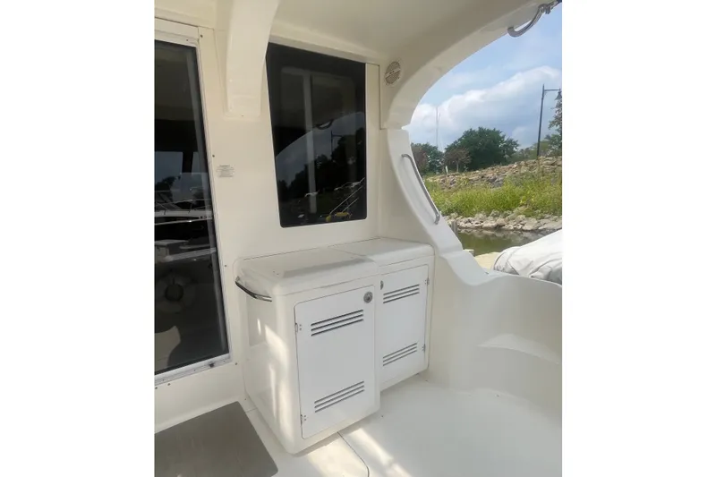 Slide: The Image of 2006 Silverton 34 Convertible boat interior with storage cabinet and window view. - 22