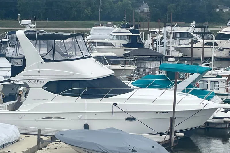 Slide: The Image of 2006 Silverton 34 Convertible yacht docked at a marina with other boats. - 8