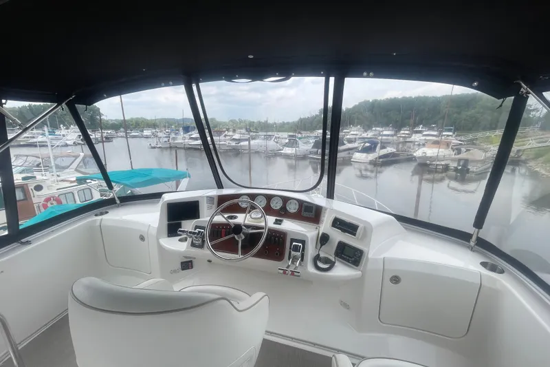 Slide: The Image of 2006 Silverton 34 Convertible yacht helm with marina view in the background. - 29