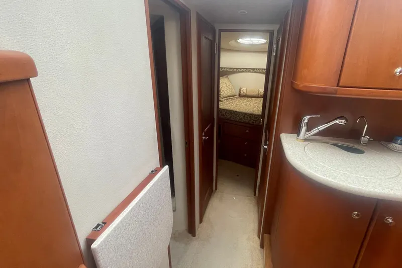Slide: The Image of 2006 Silverton 34 Convertible yacht interior with wood cabinetry and compact sink area. - 52