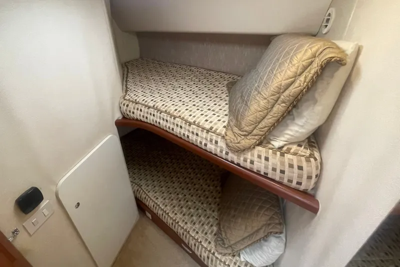 Slide: The Image of Bunk beds in 2006 Silverton 34 Convertible yacht cabin with patterned bedding. - 54