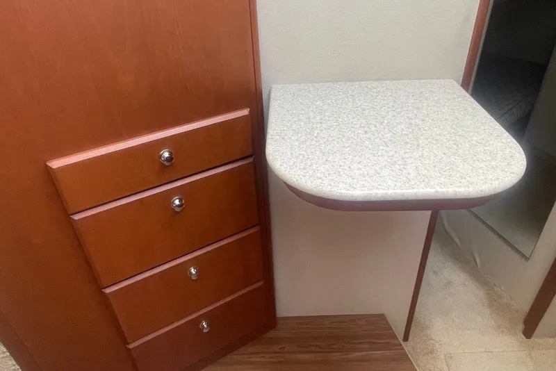 Slide: The Image of Interior of 2006 Silverton 34 Convertible with wooden drawers and a small countertop. - 51