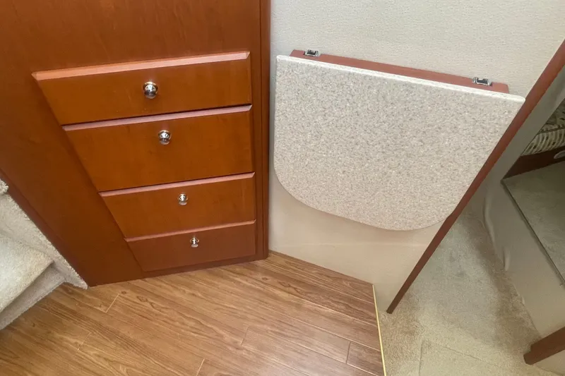 Slide: The Image of Interior of 2006 Silverton 34 Convertible with wooden drawers and foldable table. - 50