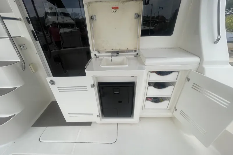 Slide: The Image of 2006 Silverton 34 Convertible yacht kitchenette with sink, storage, and mini fridge. - 26