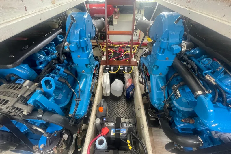 Slide: The Image of Engine room of a 2006 Silverton 34 Convertible boat with twin blue engines. - 66