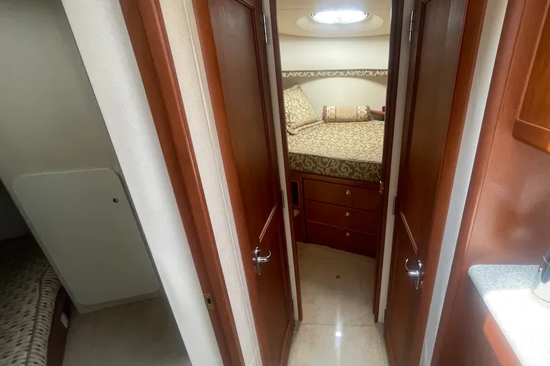Slide: The Image of Interior view of 2006 Silverton 34 Convertible yacht cabin with wood finishes and cozy bedding. - 53