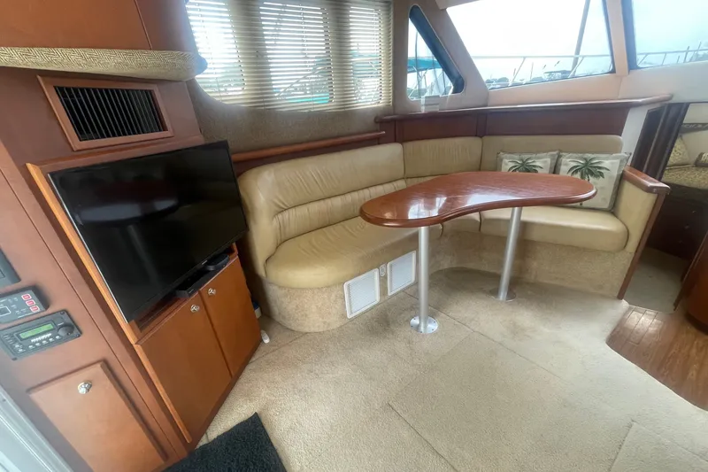 Slide: The Image of Luxurious interior of 2006 Silverton 34 Convertible yacht with cozy seating and TV. - 43