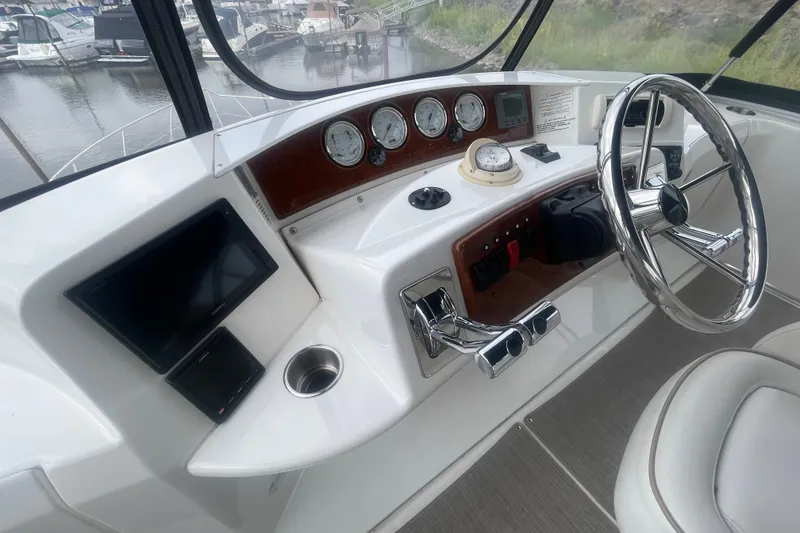 Slide: The Image of Helm of 2006 Silverton 34 Convertible yacht with steering wheel and navigation instruments. - 30