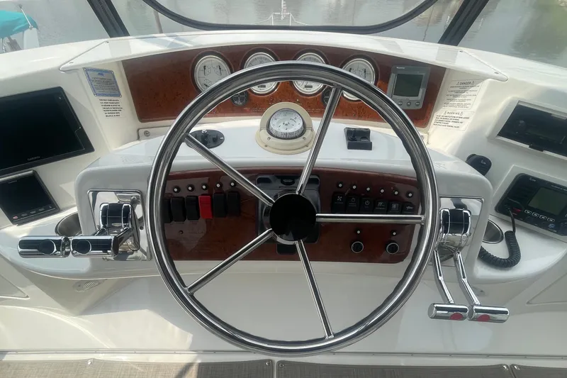 Slide: The Image of Helm of 2006 Silverton 34 Convertible boat with steering wheel and control panel. - 36