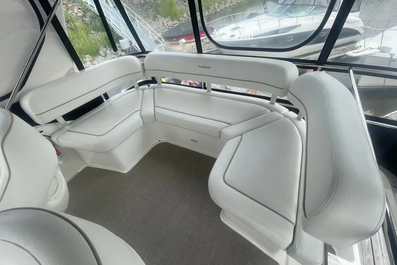 Slide: The Image of Interior seating of 2006 Silverton 34 Convertible yacht, featuring white cushioned benches. - 33