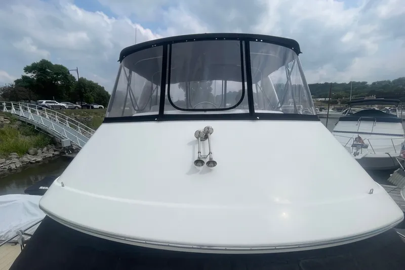 Slide: The Image of 2006 Silverton 34 Convertible boat docked at marina under cloudy sky. - 17