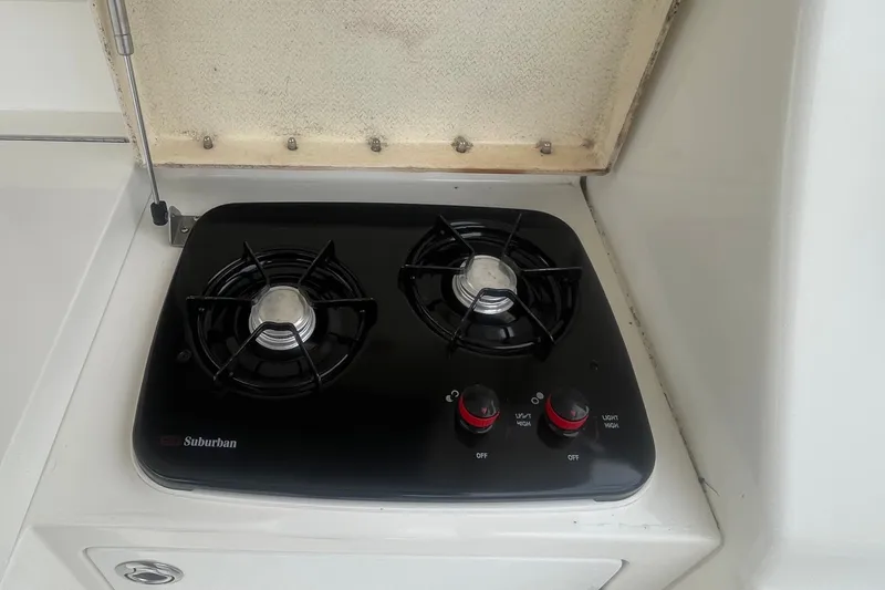 Slide: The Image of Two-burner stove on 2006 Silverton 34 Convertible yacht, featuring Suburban brand controls. - 24