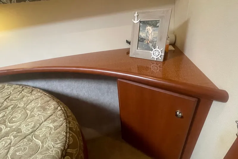 Slide: The Image of Interior of 2006 Silverton 34 Convertible with wooden cabinet and decorative photo frame. - 57