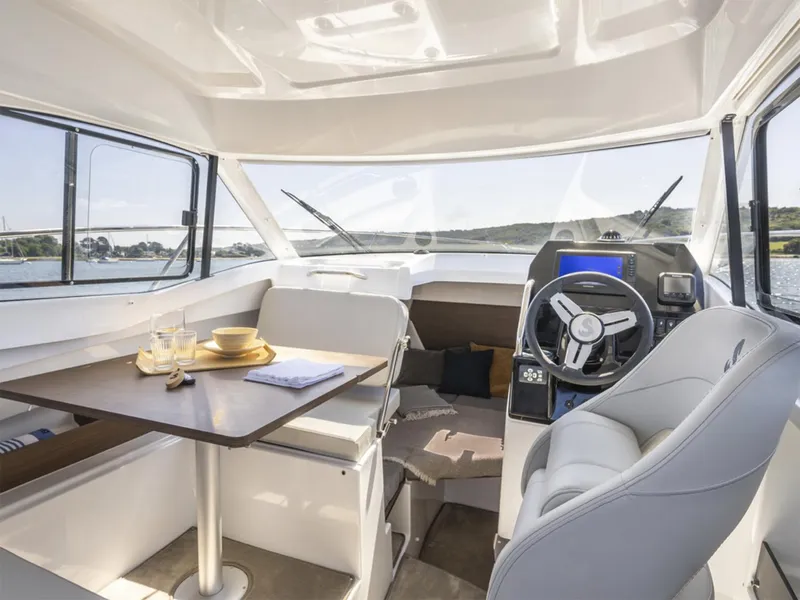 Slide: The Image of Manufacturer Provided Image: Interior of 2026 Beneteau Antares 7 Fishing boat with helm, seating, and dining area. - 4