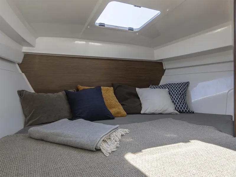 Slide: The Image of Manufacturer Provided Image: Cozy cabin interior of 2026 Beneteau Antares 7 Fishing boat with cushions and skylight. - 5