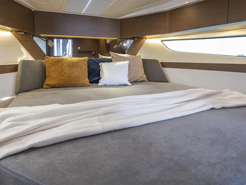 Slide: The Image of Manufacturer Provided Image: Luxurious cabin interior of 2026 Beneteau Antares 11 Fly with cozy bedding. - 4
