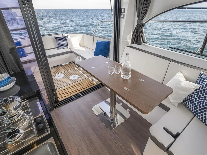 Slide: The Image of Manufacturer Provided Image: Interior of 2026 Beneteau Antares 11 Fly yacht with ocean view, featuring elegant seating and dining area. - 3