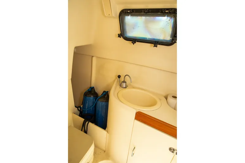 Slide: The Image of Interior of 2004 Hunter 260 sailboat bathroom with sink and window. - 17