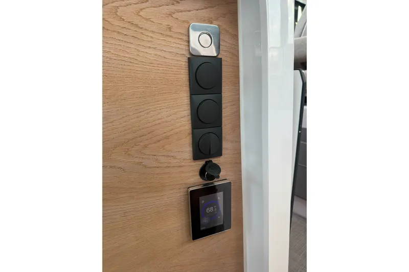 Slide: The Image of Control panel on 2023 Axopar 45 XC Cross Cabin, featuring modern switches and digital display. - 36