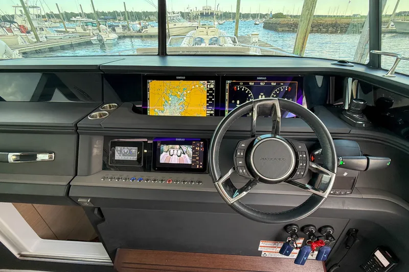Slide: The Image of 2023 Axopar 45 XC Cross Cabin helm with advanced navigation displays and controls. - 22