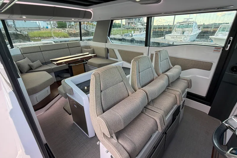 Slide: The Image of Interior of 2023 Axopar 45 XC Cross Cabin with modern seating and large windows. - 15
